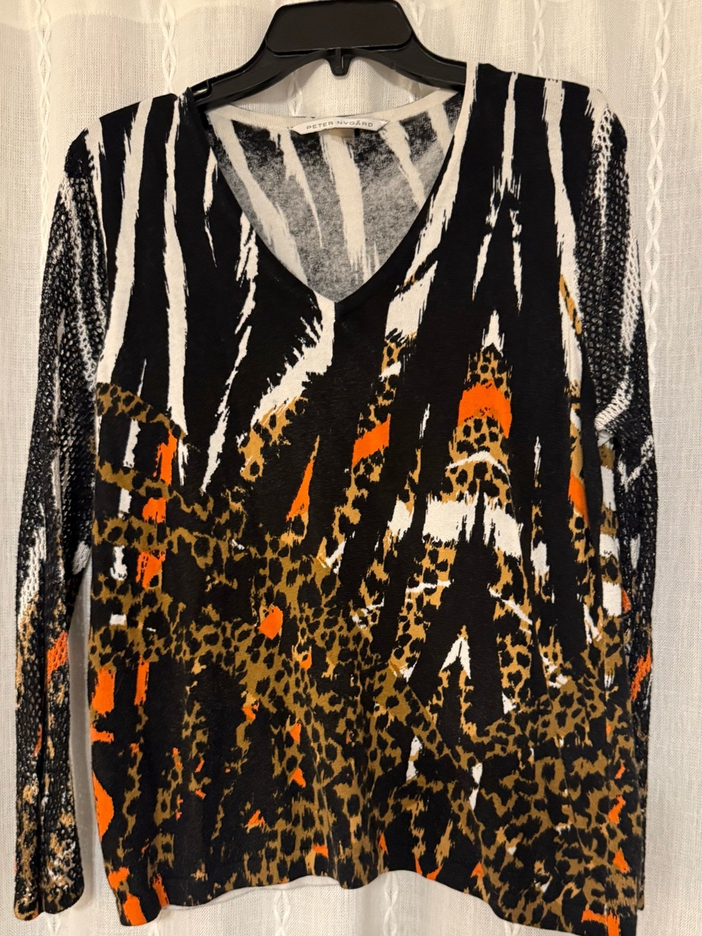 Peter Nygard V-neck top. Bold mixed animal print pattern w/mesh sleeves.
